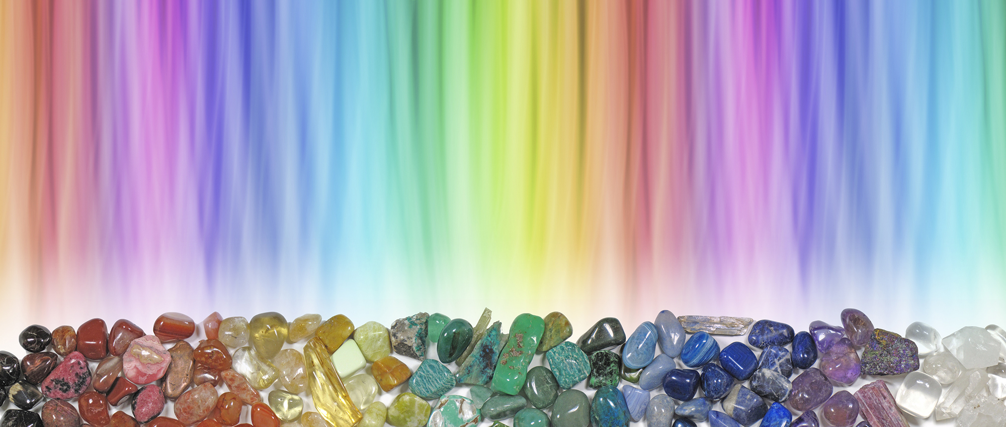 row of crystals and gemstones with glowing colored light