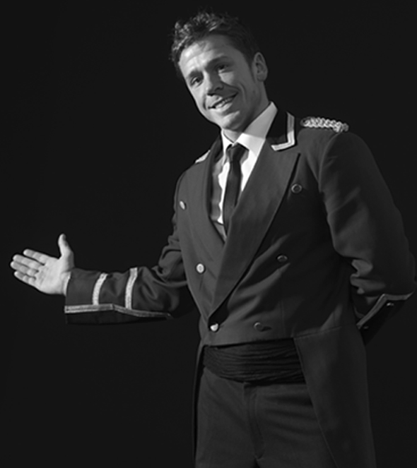 man in train conductor uniform pointing